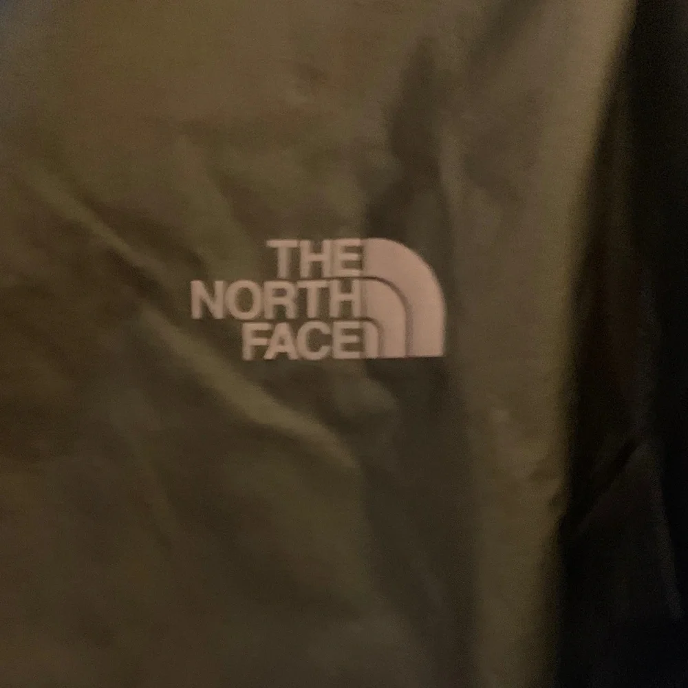 The North Face Men's Black Raincoat with Bright Yellow Zipper